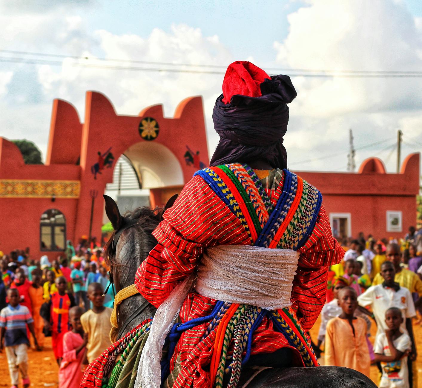 a man in colorful outfit riding a horse